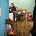 Harry and Gertrude, puppets created by "Sesame Street" performer Michael Earl, welcome a visitor to the Show & Tell exhibit in the Global Museum